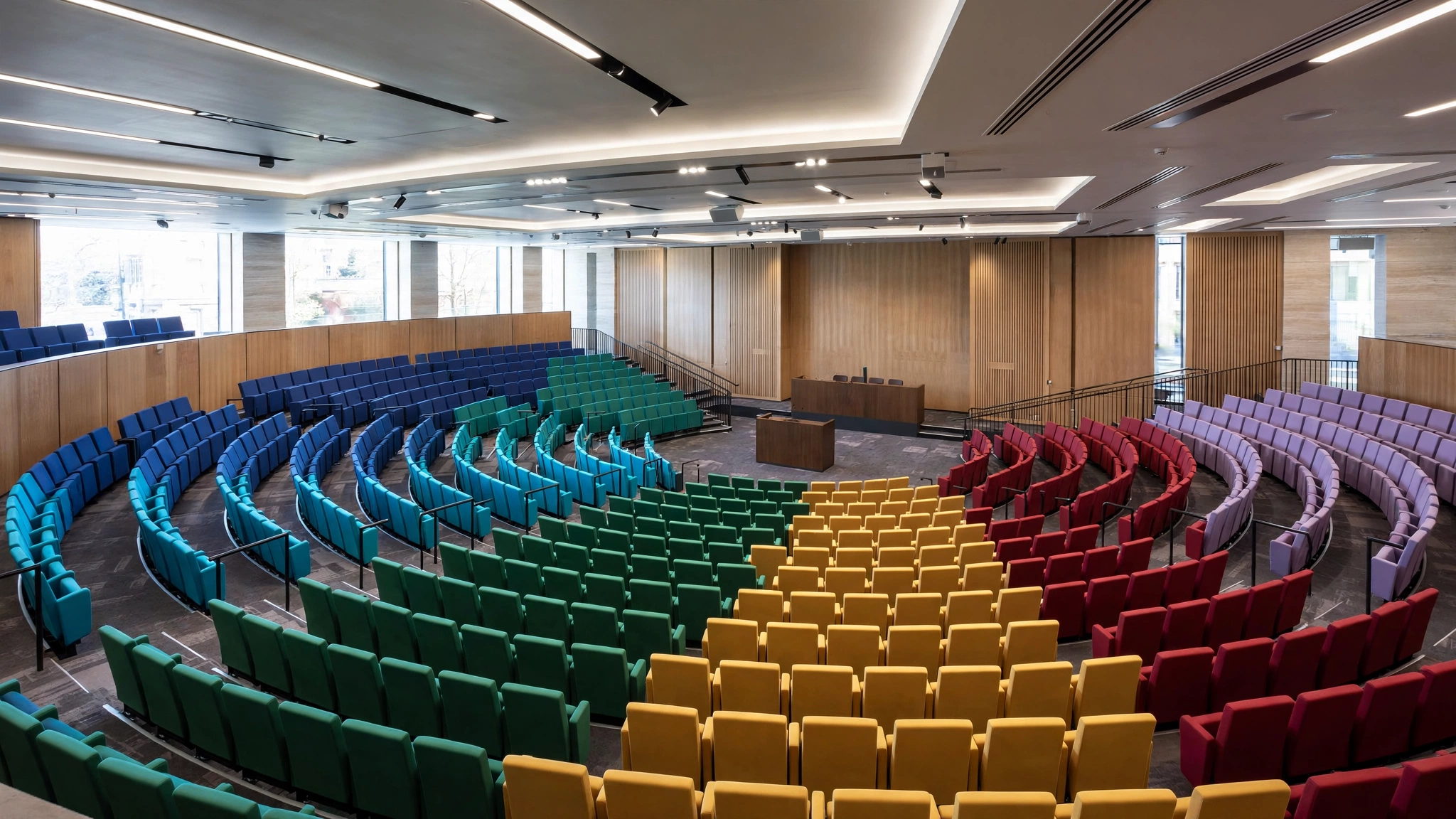 A council chamber with empty seats in different colours, showing several parties sharing power, no single party holding a majority.
